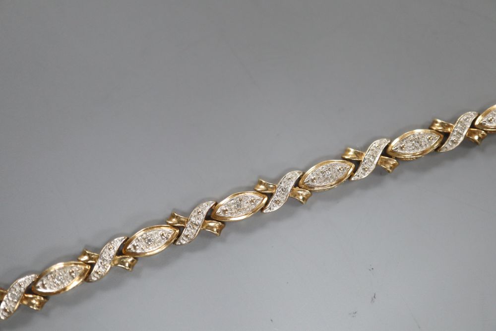 A modern 375 yellow metal and diamond chip set line bracelet, 18.9cm, gross 7.4 grams.